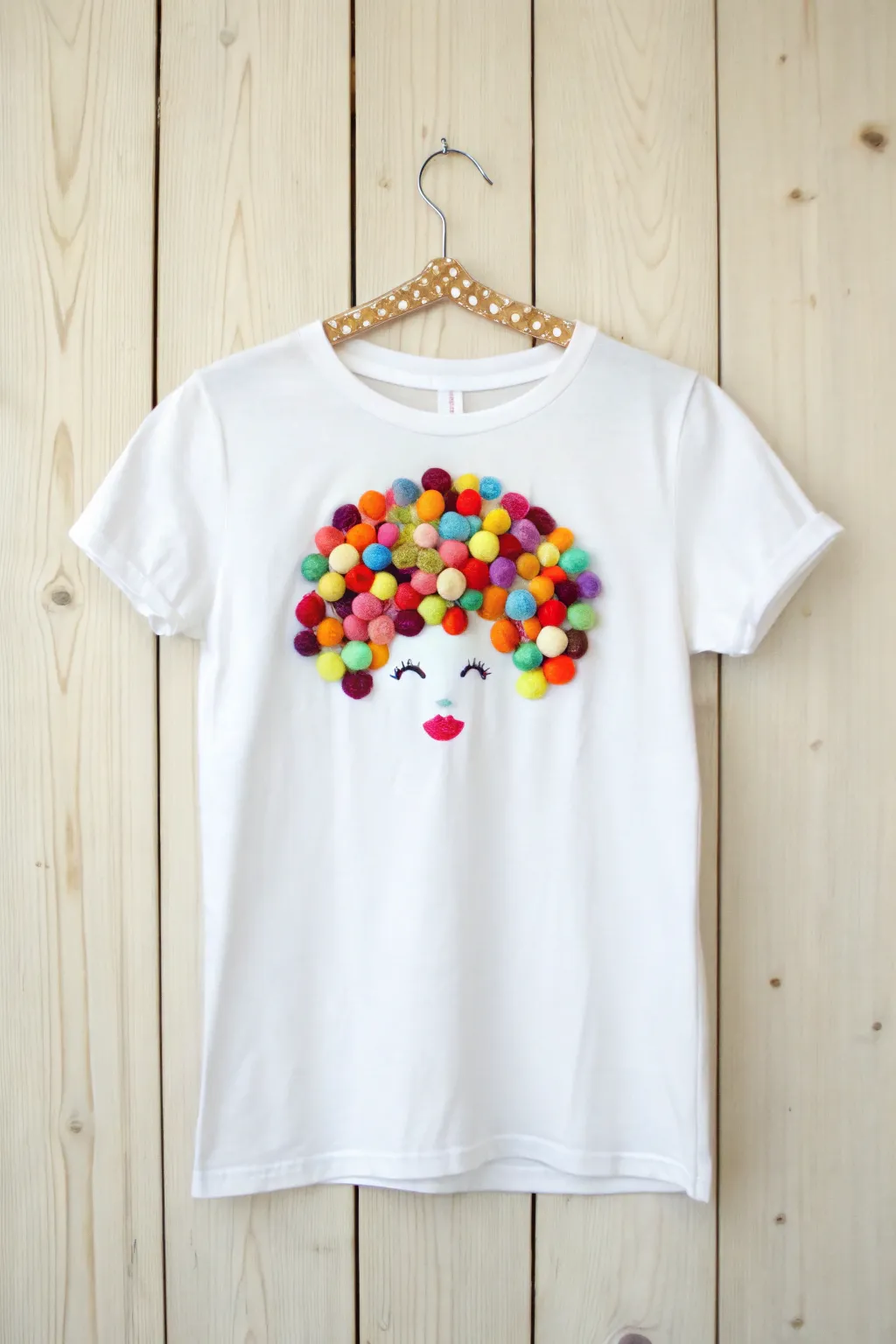 Craft a masterpiece: Transform a simple tee into a colorful conversation starter with 100 pom-poms!