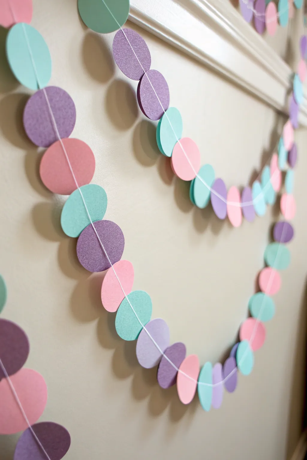 Brighten your space with a touch of whimsy: a handmade colorful paper garland that brings joy and simplicity to any room.