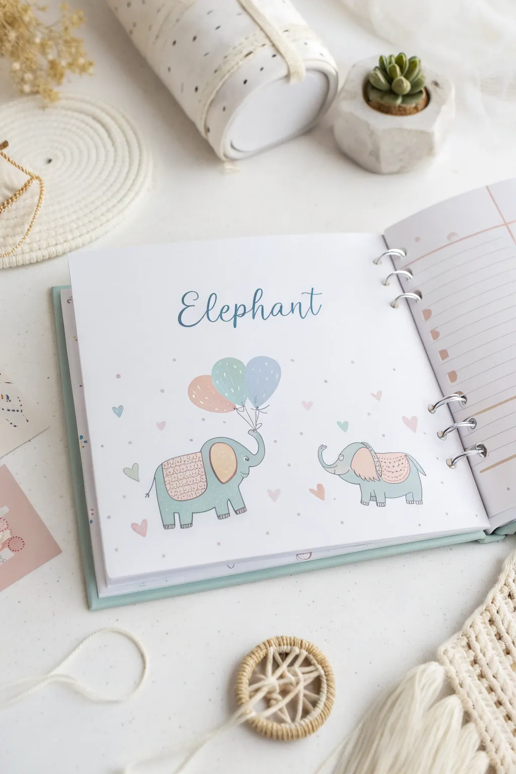 Craft your baby's first memories with adorable elephant-themed scrapbook pages in soothing pastels. Perfect for a touch of minimalist charm!
