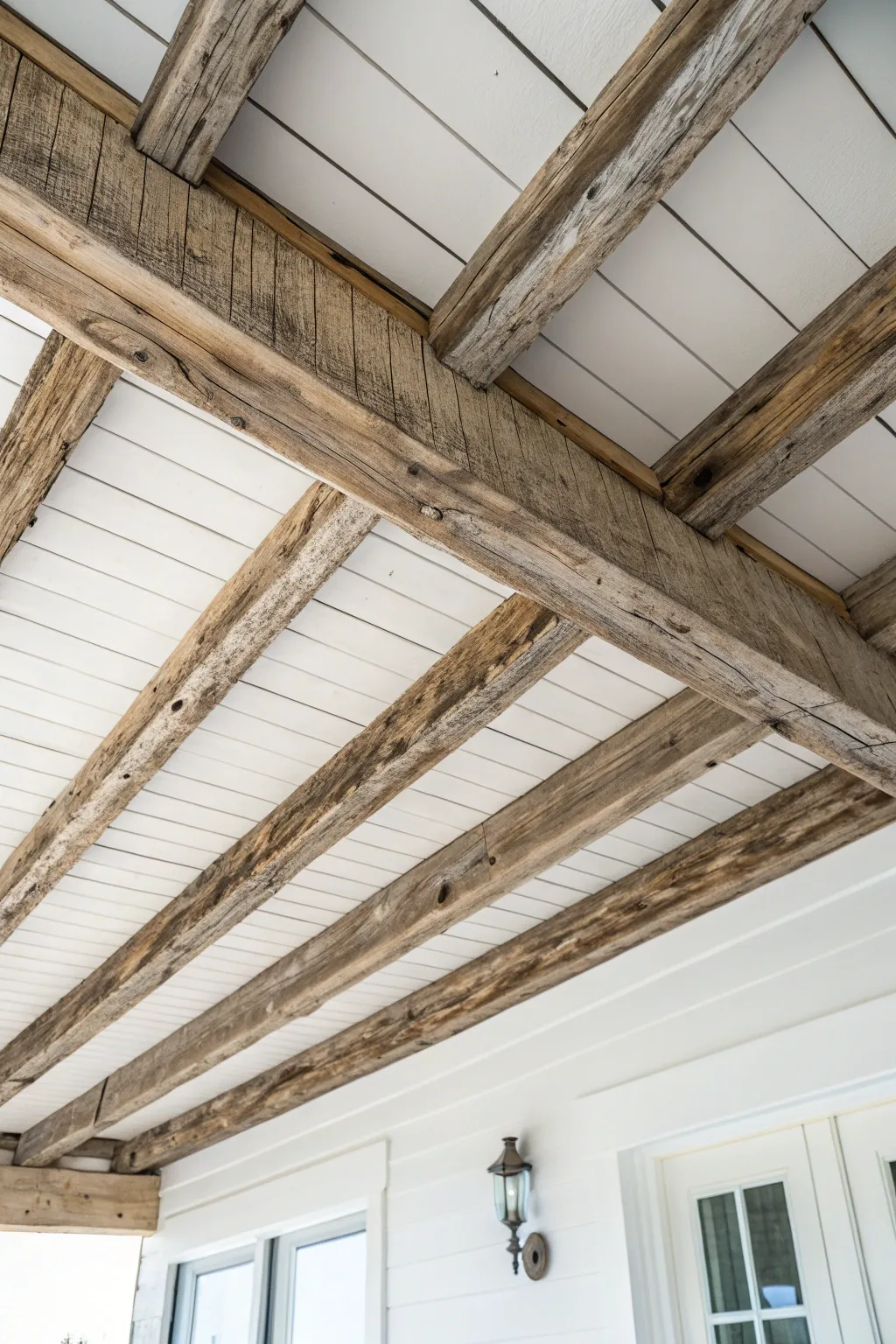 Exposed wooden beams bring rustic charm to a beach house ceiling.
