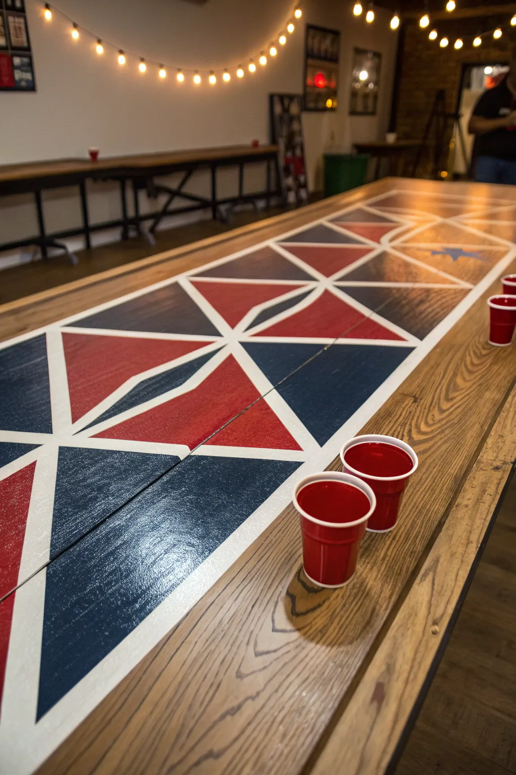 Elevate your game with a handcrafted beer pong table featuring bold geometric designs.