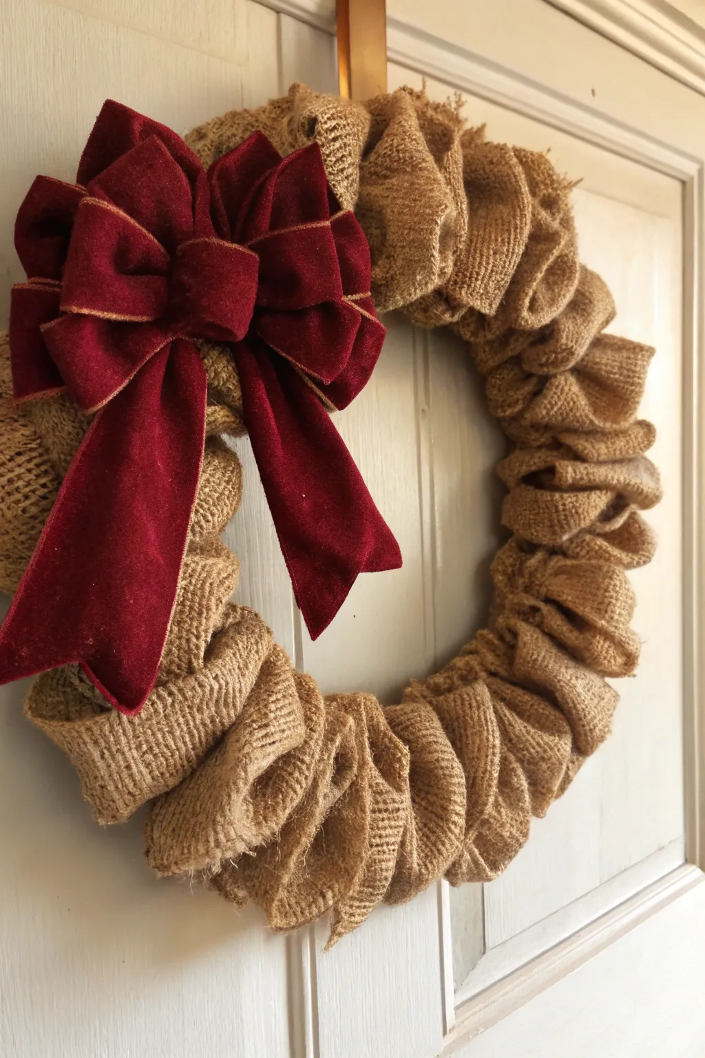 Embrace timeless holiday elegance with a classic red bow burlap wreath.