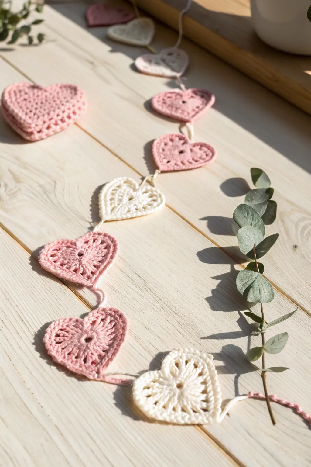 Add a touch of romance with a handcrafted crochet heart garland, perfect for a minimalist boho decor.