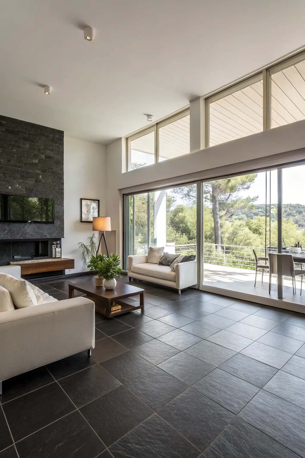 A sleek minimalist living room with dark tile flooring.