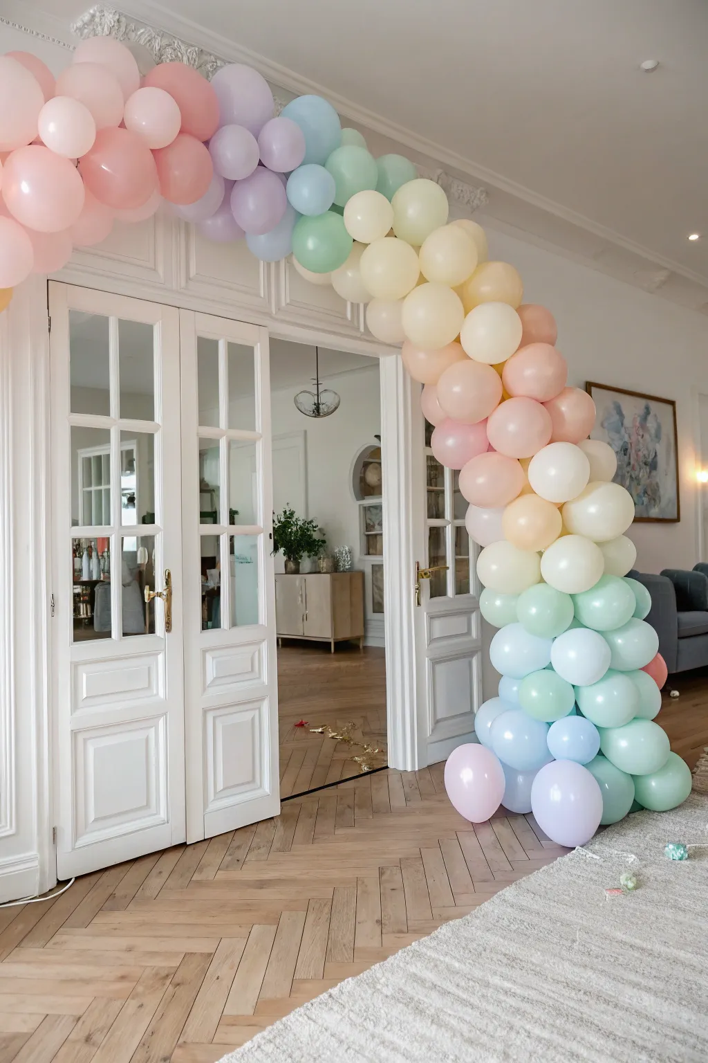 Add a pop of color to your celebration with a charming rainbow balloon arch, perfect for a touch of whimsy in a minimalist space.