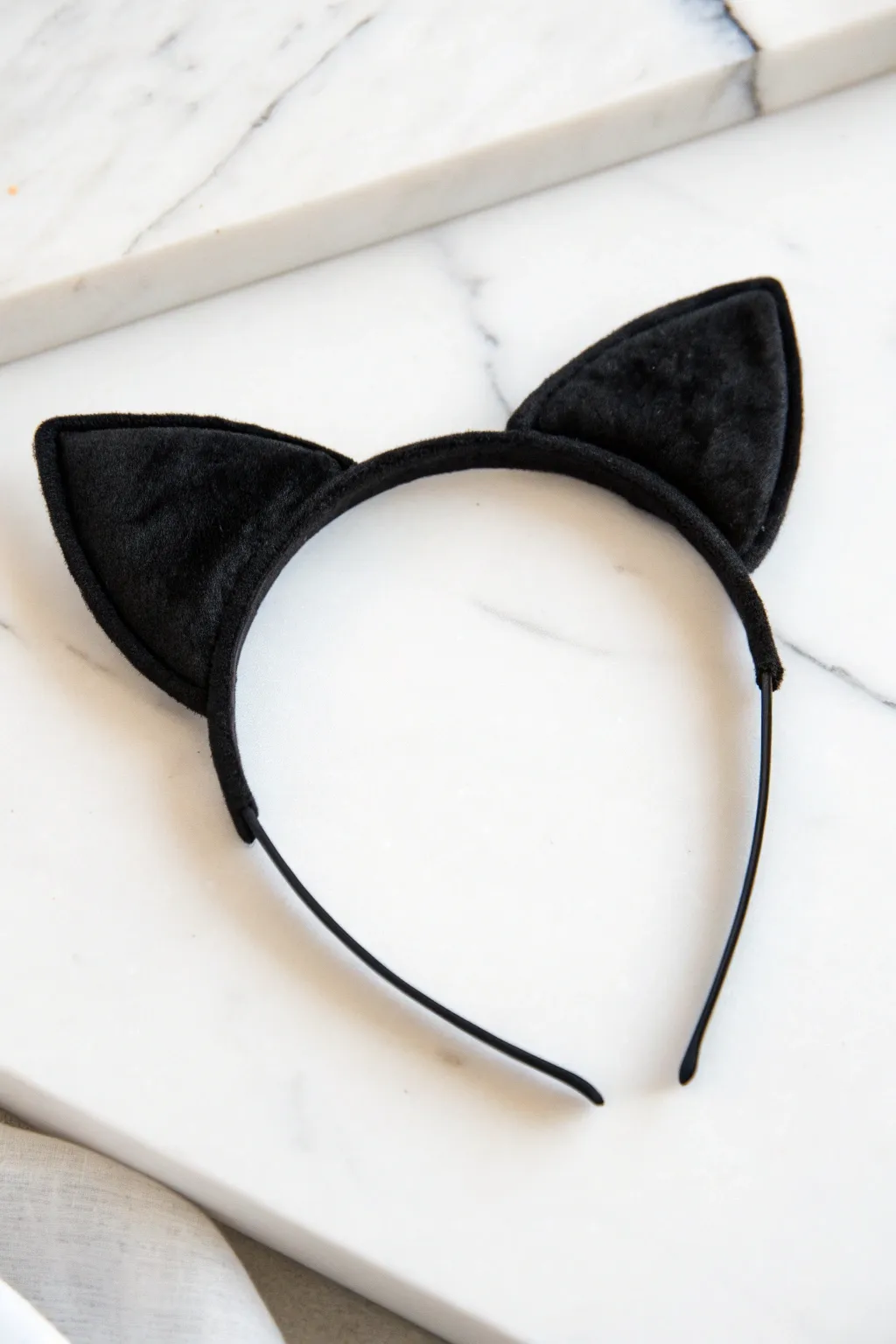 Channel your inner feline with these chic black cat ears for a quick and stylish Halloween look!