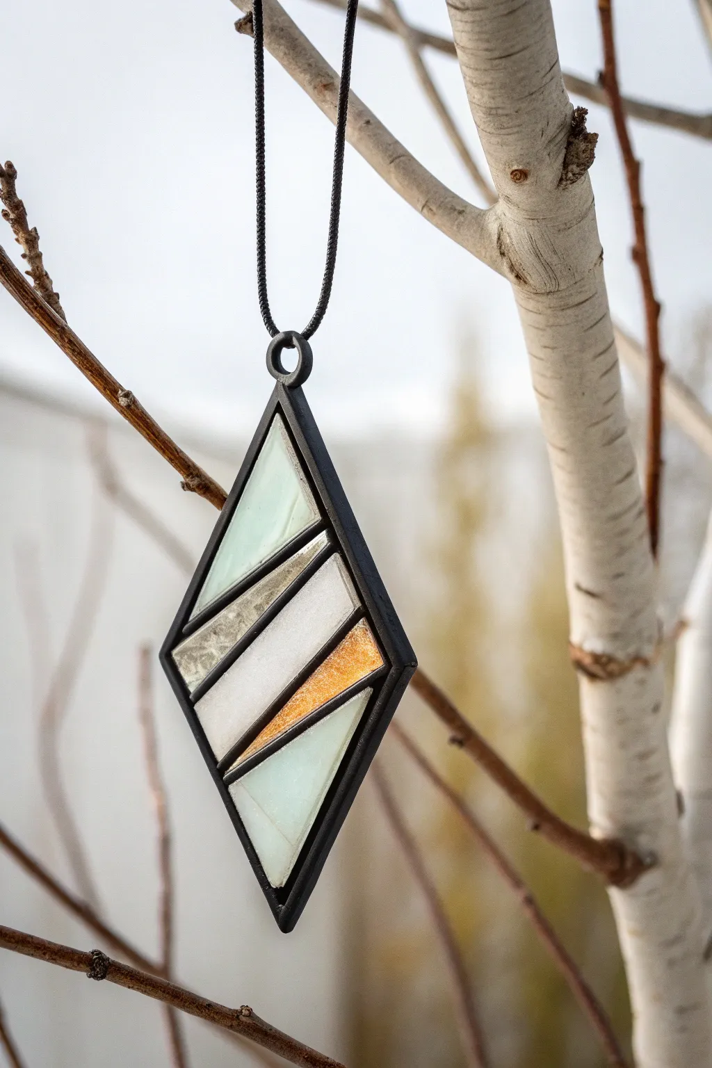 Embrace simplicity and elegance with this striking geometric fused glass pendant.