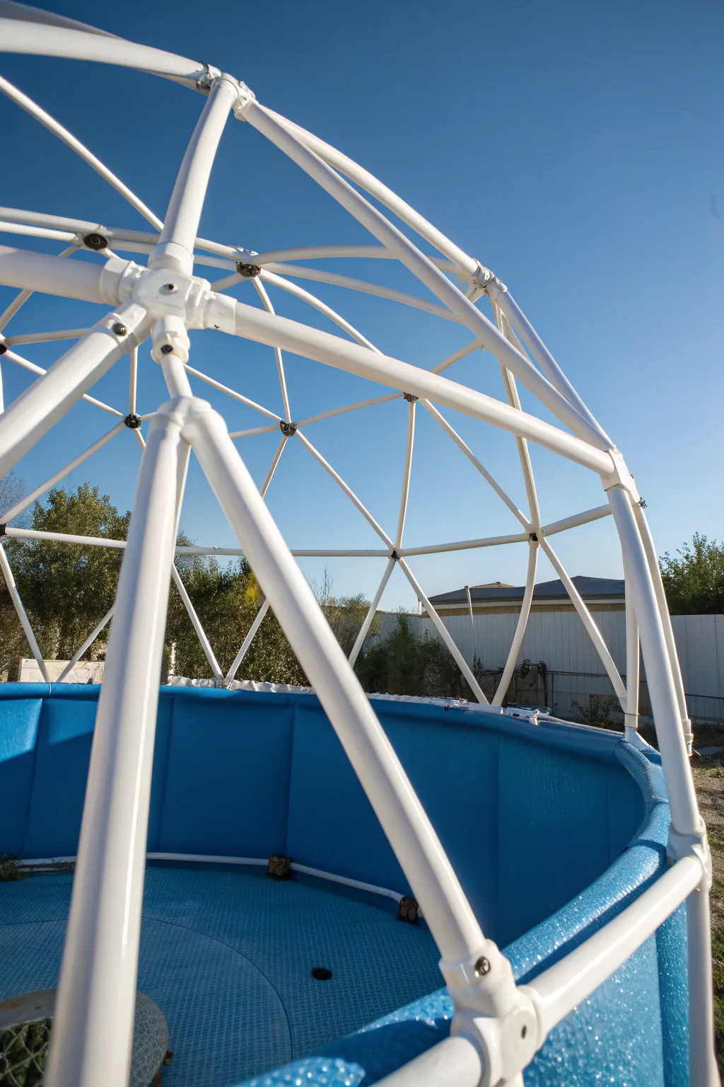 Craft a sturdy pool cover with a touch of DIY brilliance using PVC pipes.
