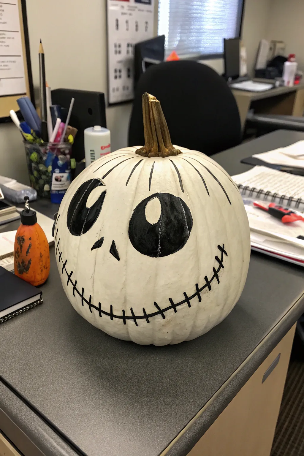 A pumpkin transformed into the iconic Jack Skellington, perfect for a Halloween-themed office.