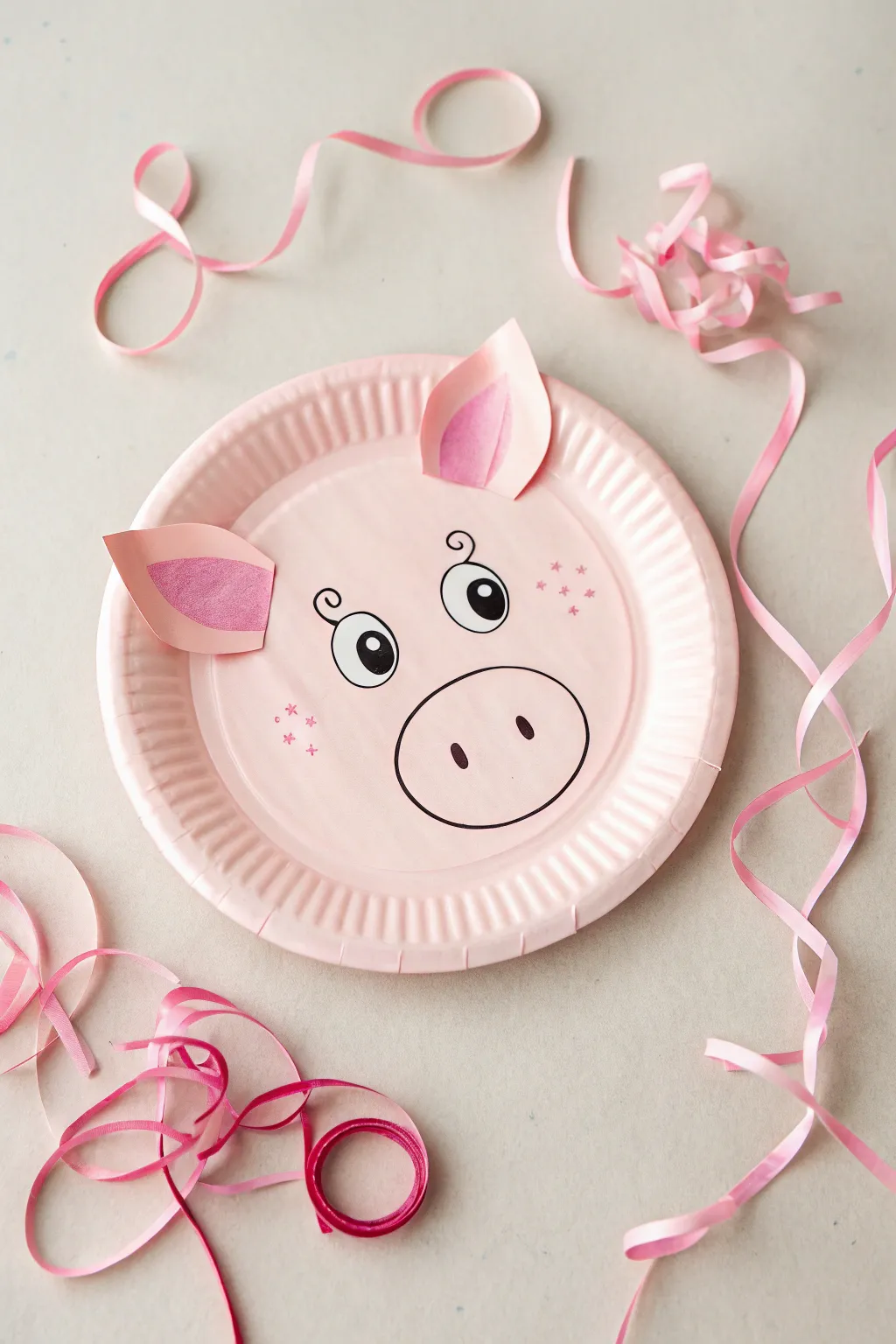 Bring a touch of whimsy and Scandinavian charm to your crafting with this delightful paper plate pig face!