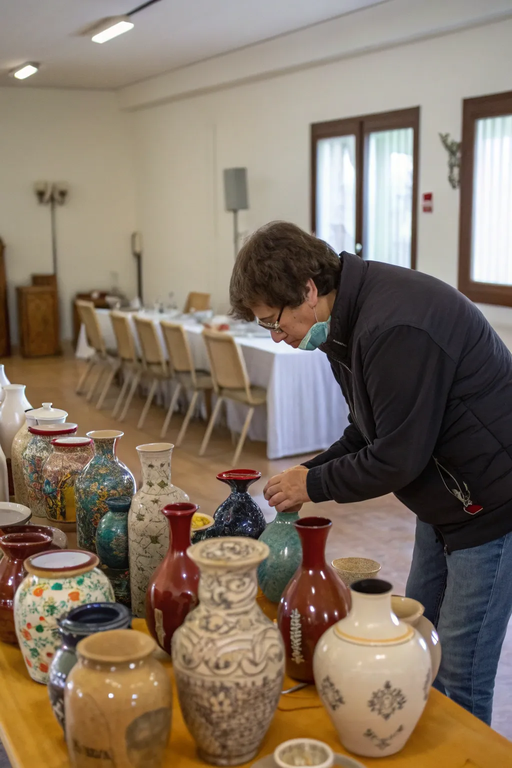 A thoughtful decluttering session with vases, preparing for a more organized storage solution.