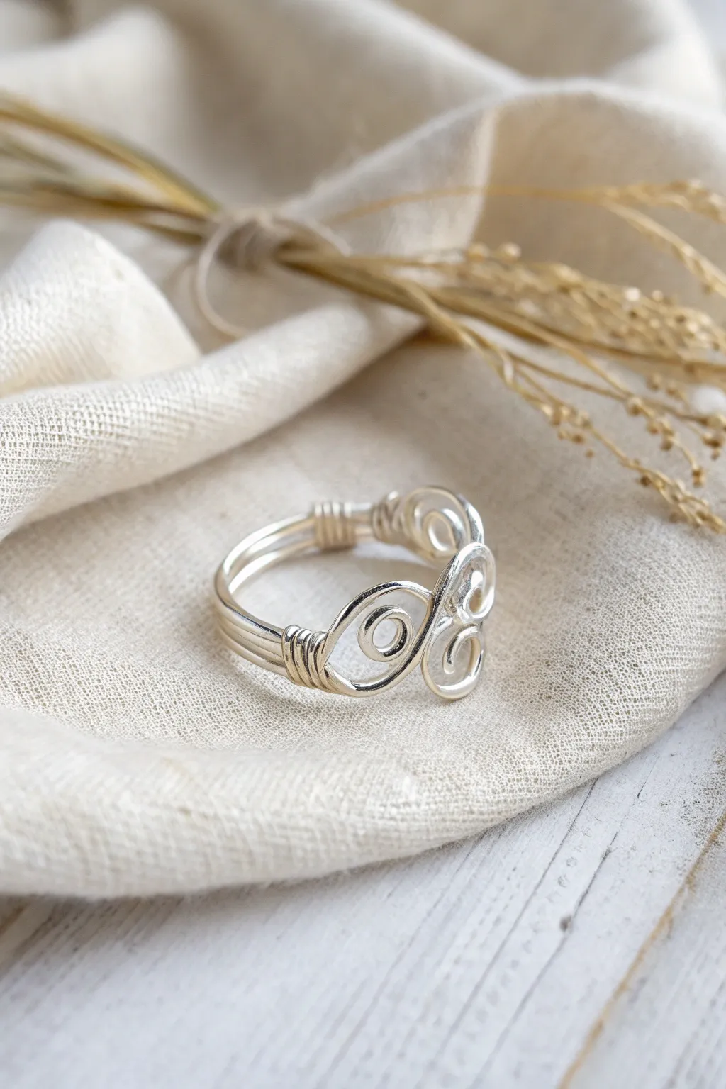 Discover the beauty in simplicity with intricate wire swirls that captivate the eye.