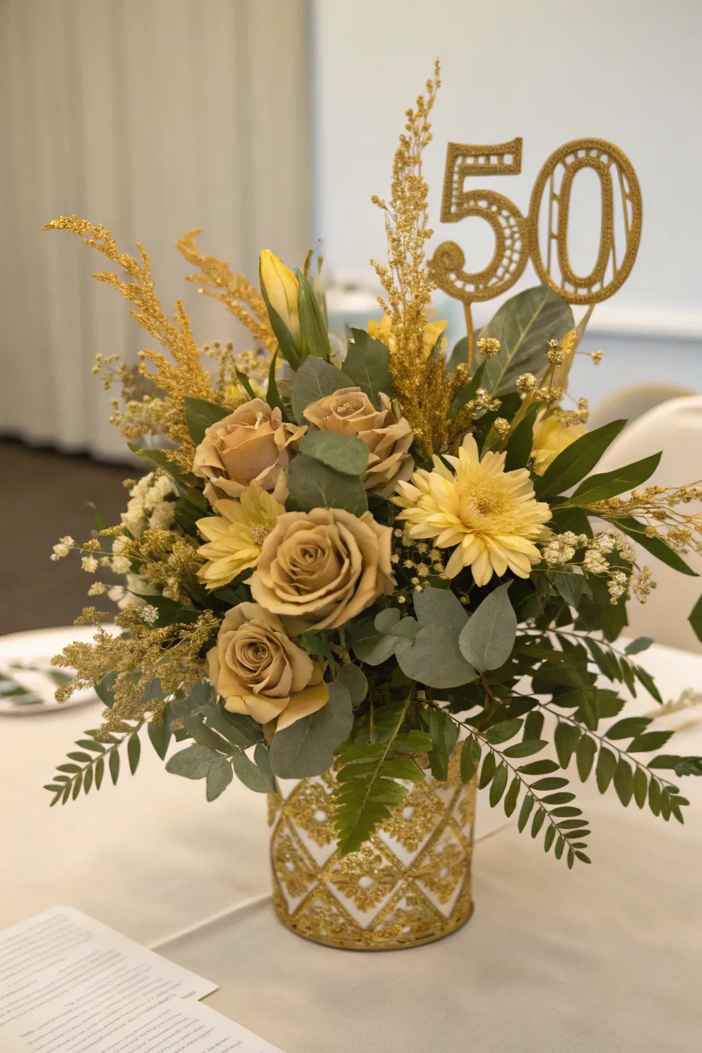 A luxurious floral arrangement featuring gold-tinted blooms.