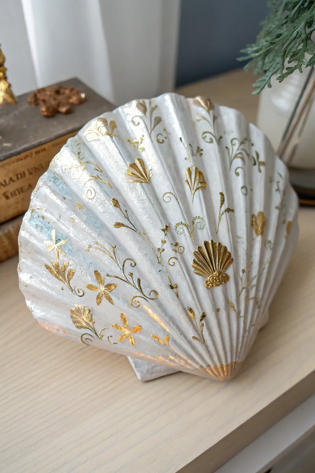 Elevate your decor with a touch of luxury: metallic-accented acrylic seashell art.