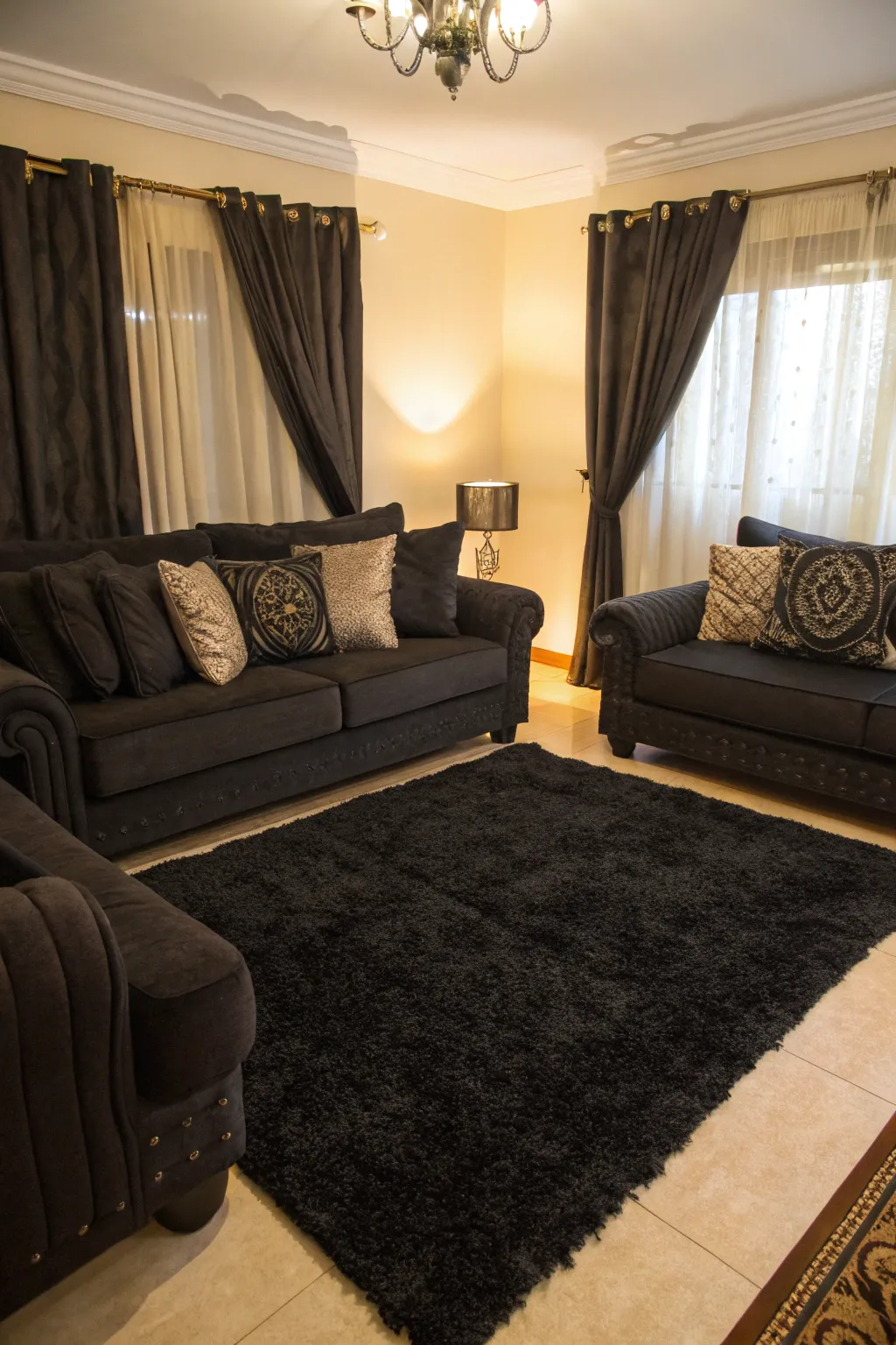 Matching dark textiles with a black rug creates a seamless and sophisticated look.
