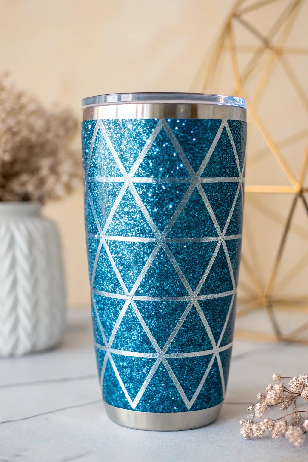 Elevate your drinkware with the elegant charm of blue glitter and geometric patterns.