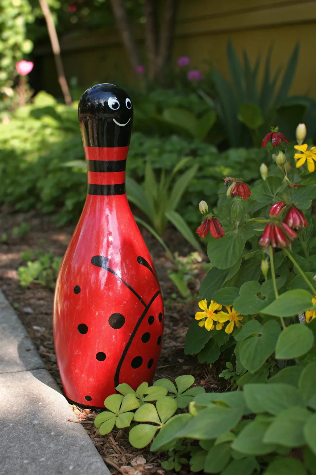 Transforming a bowling pin into a charming garden ladybug.