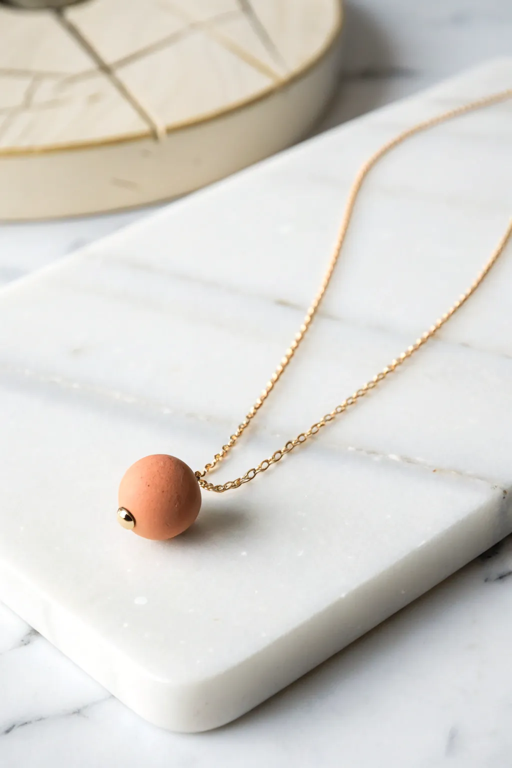 Embrace simplicity with this elegant clay bead necklace, where less truly is more.