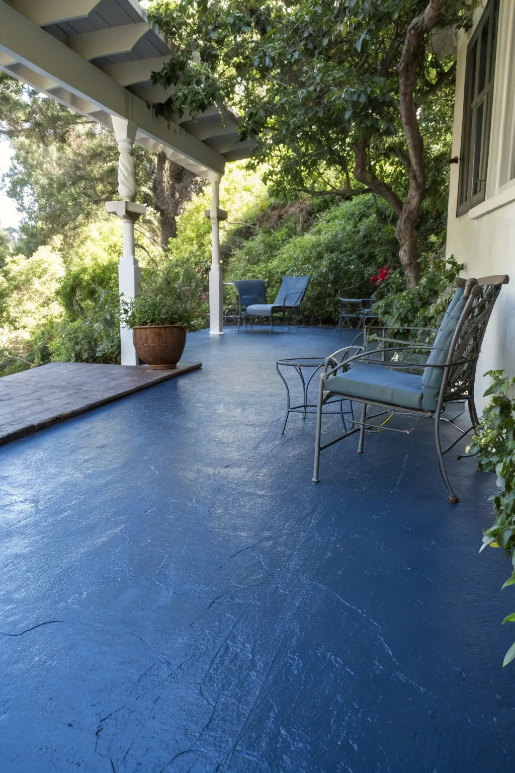 Dive into the depths of monochrome magic with a navy-painted patio masterpiece.