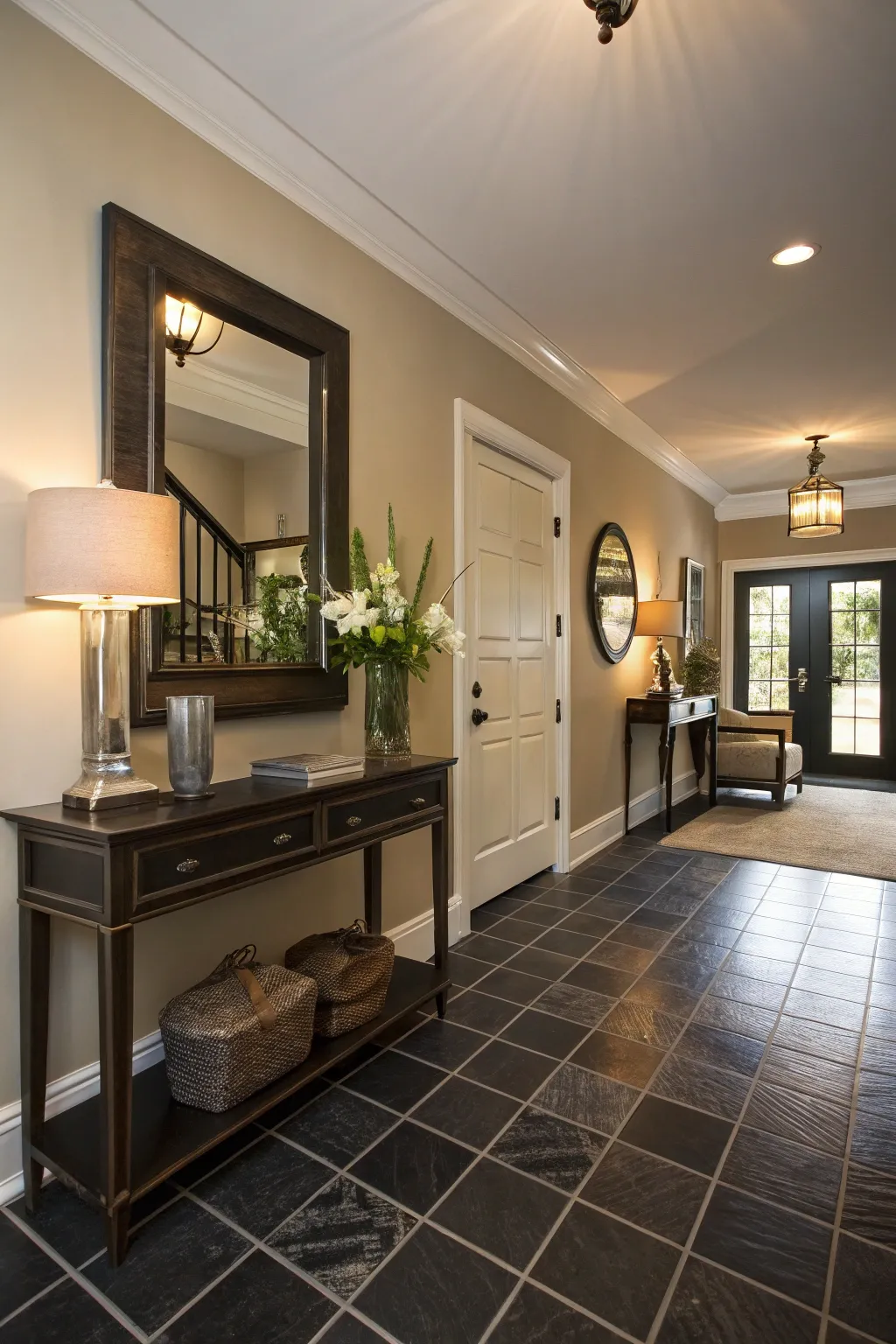 A welcoming entryway with dark tile flooring.
