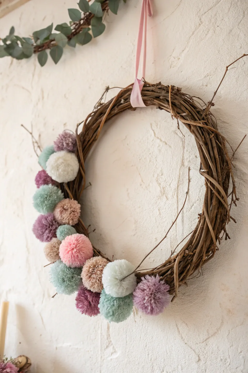 Add a playful pop to your decor with a pom pom adorned grapevine wreath!