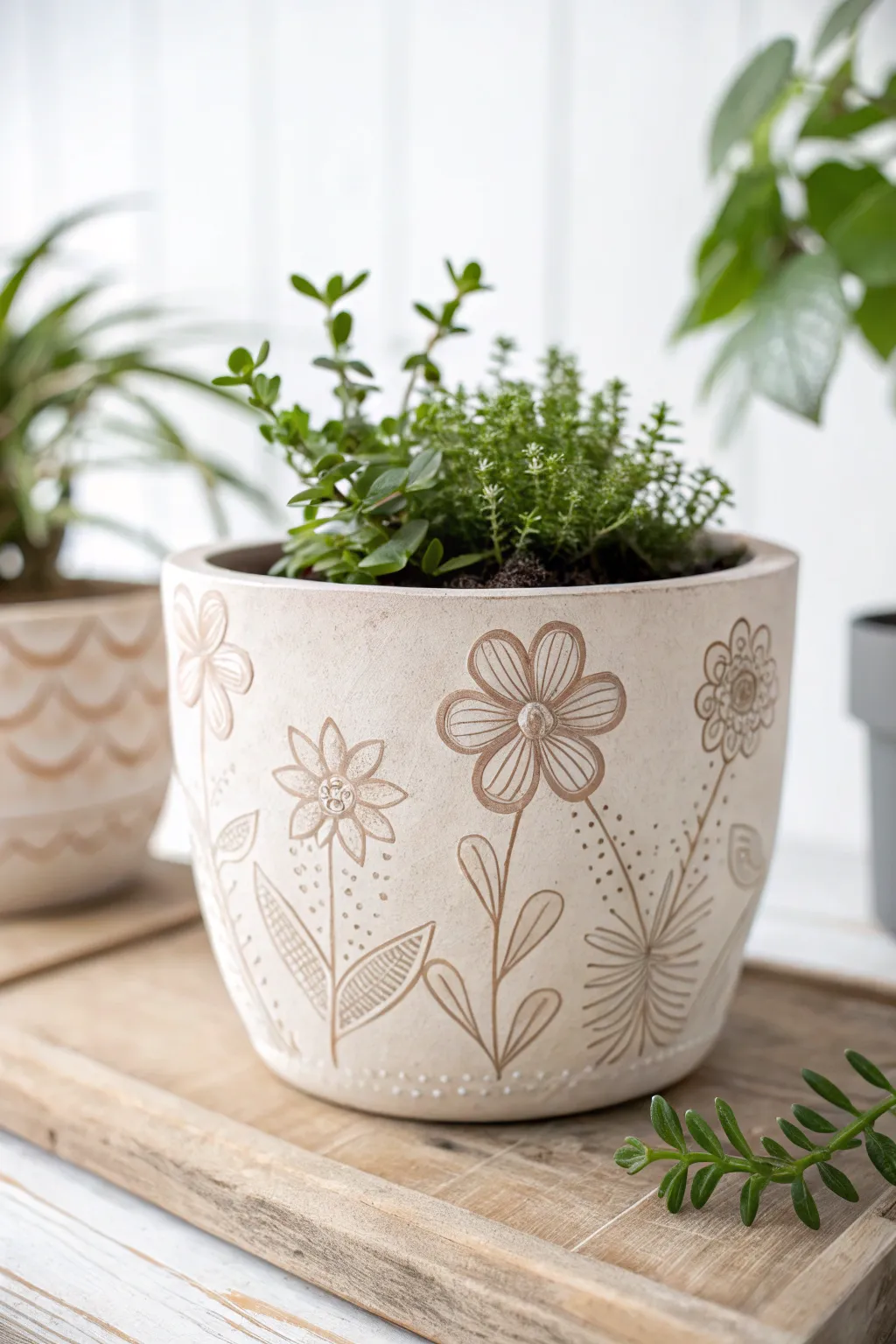 Elevate your green space with a handcrafted clay planter adorned with delicate stamped floral patterns.