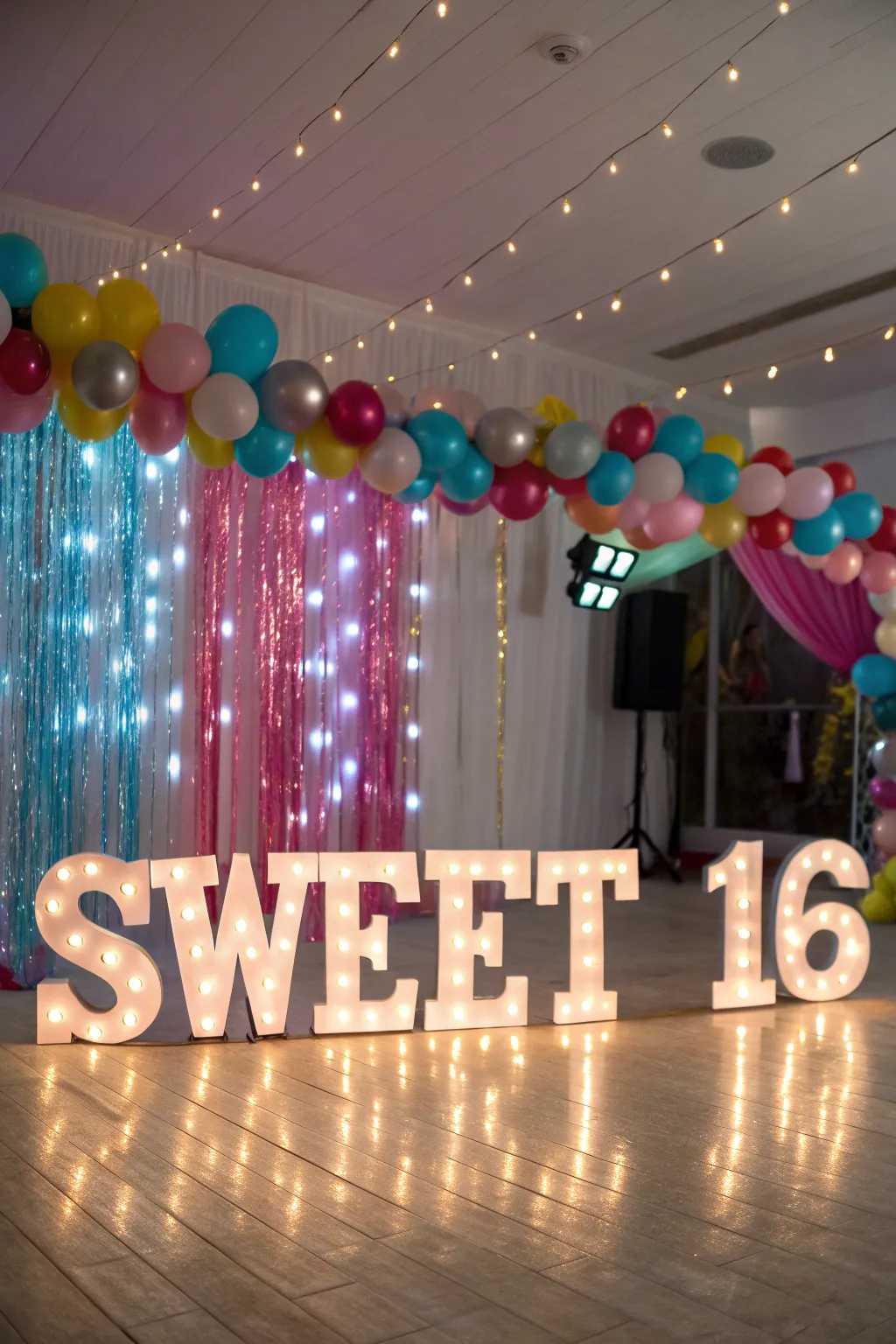 Chic marquee letters illuminate the space, adding a playful yet elegant touch.