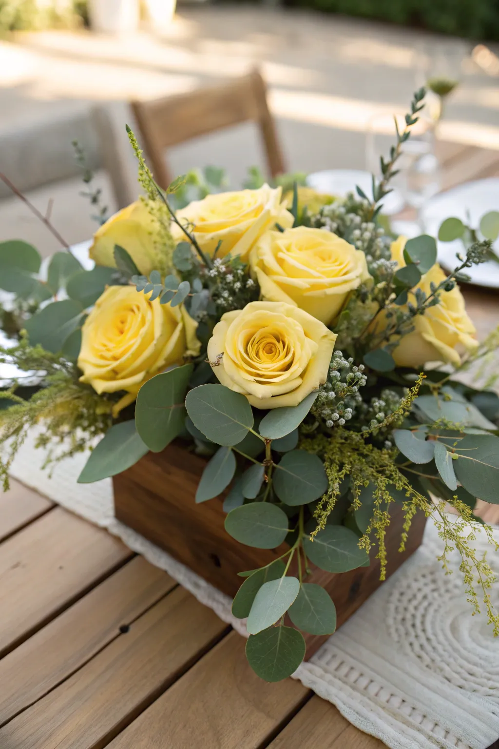 Garden fresh with yellow roses and green foliage.