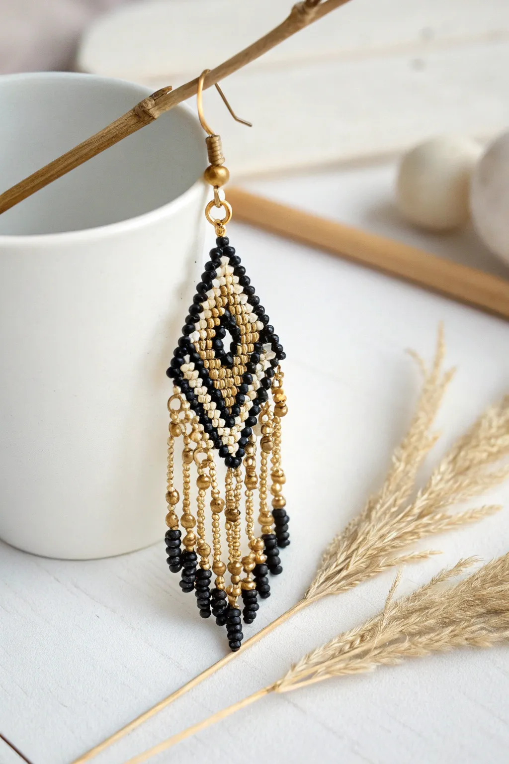 Elevate your style with Art Deco elegance: Black and gold beaded earring.