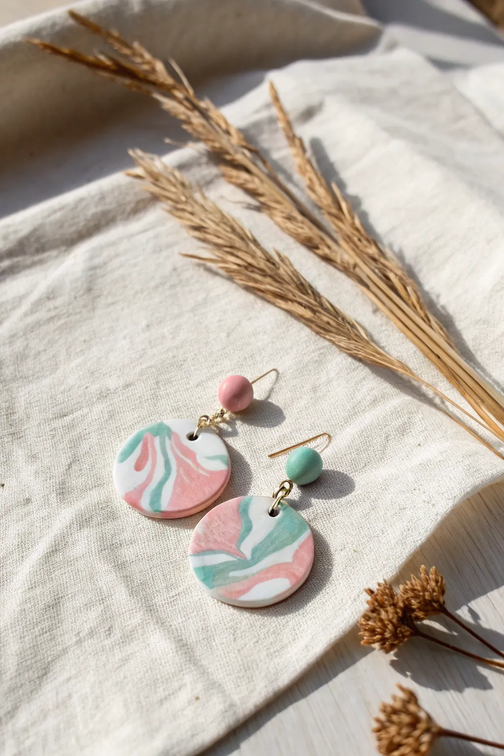 Embrace the elegance of marbled clay with these stunning, handcrafted earrings.