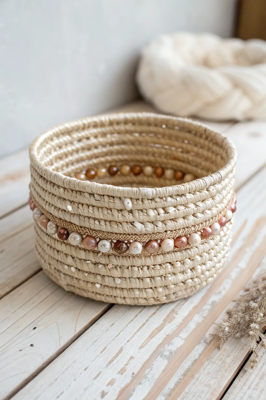 Elevate your space with the simple elegance of a bead-adorned coil basket.