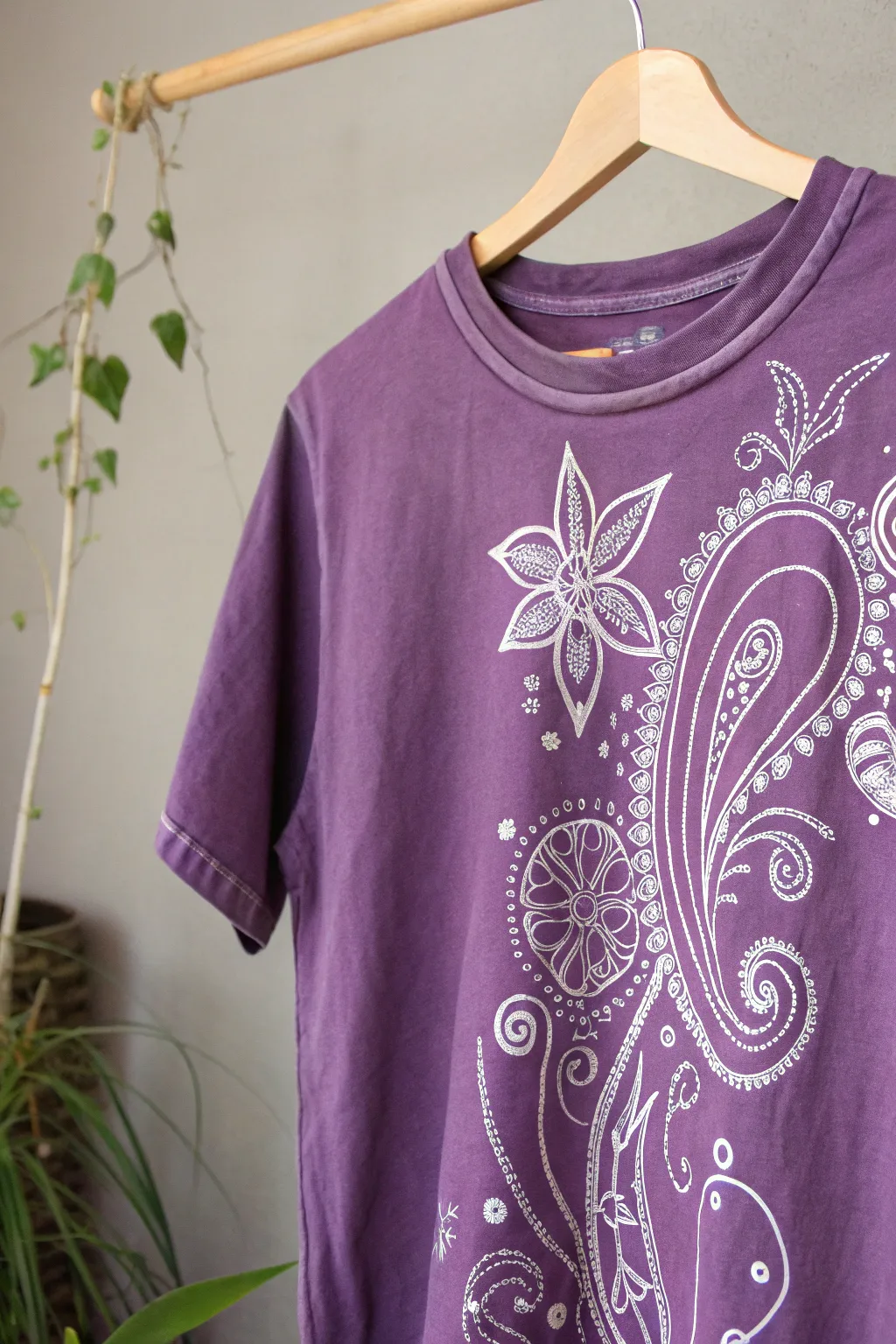 Unleash your creativity with the mesmerizing bleach art technique on a purple tee, where simplicity meets striking elegance.