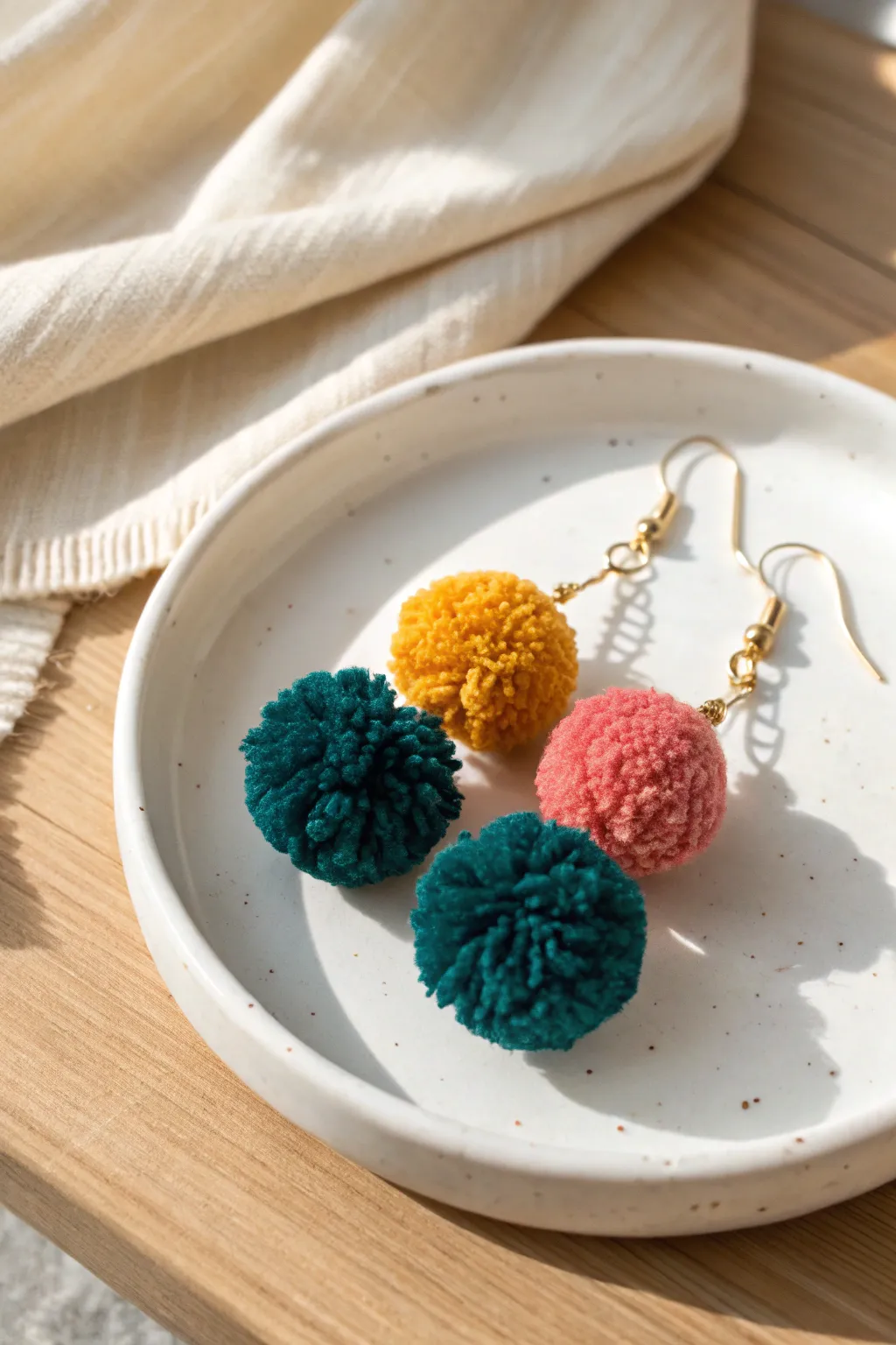 Add a pop of playfulness to your style with these handcrafted pom pom earrings!