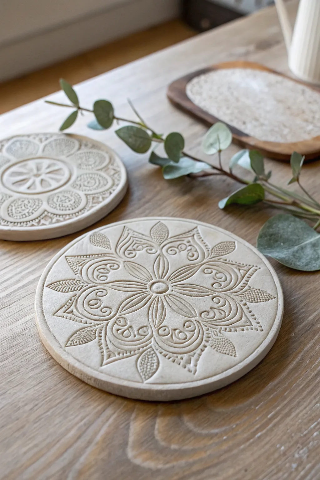Transform your space with stamped clay coasters that blend Scandinavian simplicity with Boho charm.