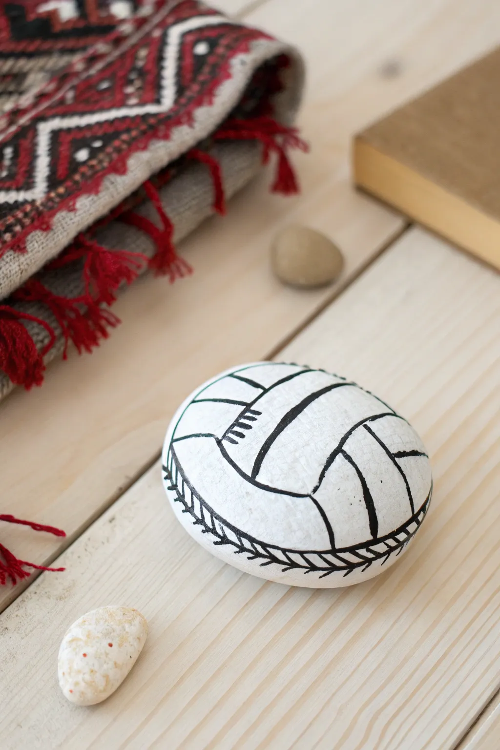 Add a touch of sporty elegance to your space with these hand-painted volleyball rocks - perfect for the minimalist at heart.
