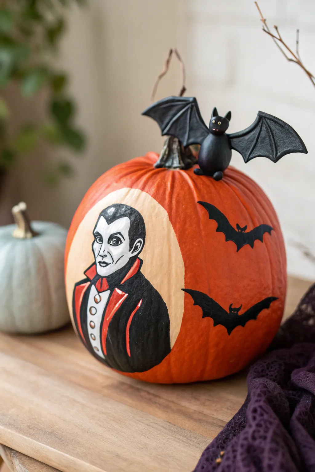 Elevate your Halloween decor with this stunning Dracula pumpkin, complete with a charming clay bat companion!