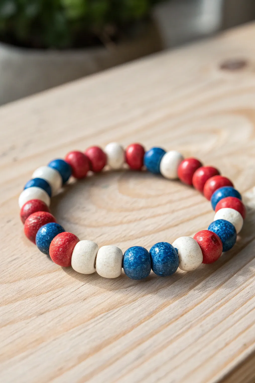 Celebrate freedom in style with this handcrafted clay bead bracelet in patriotic hues.