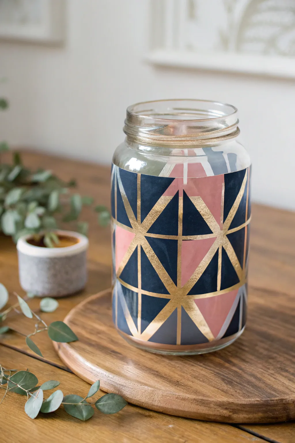 Transform ordinary glass jars into stunning art pieces with bold geometric designs. Embrace simplicity and elegance in your decor.