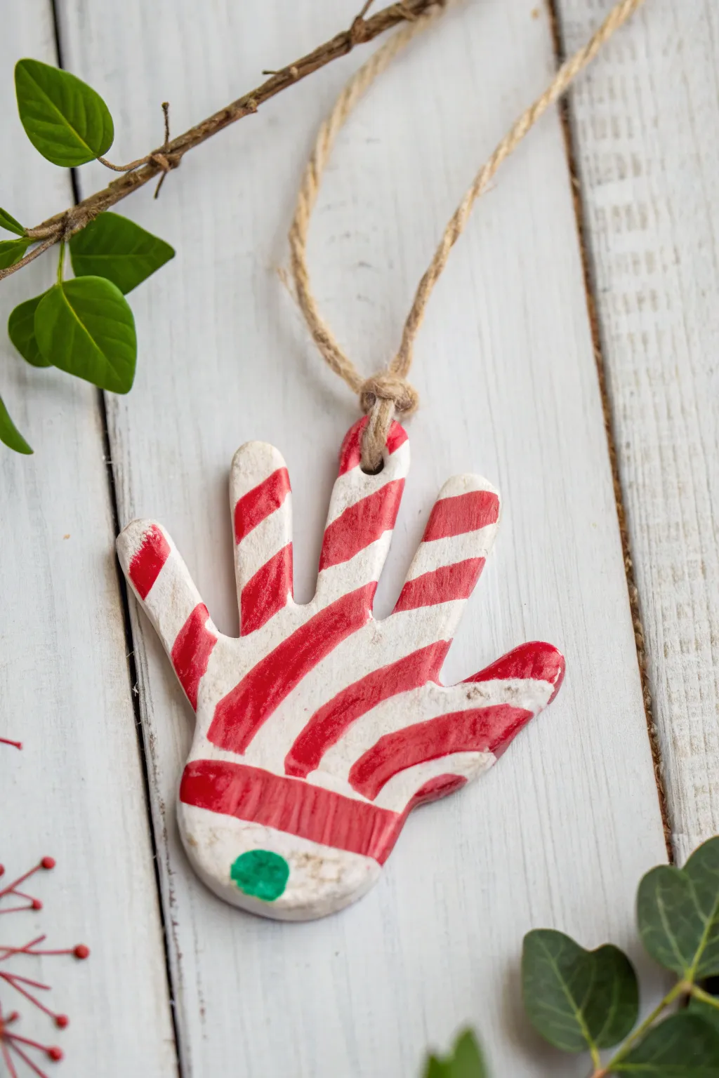 Sweet holiday memories captured in a candy cane handprint ornament, perfect for adding a touch of festive charm to your minimalist décor.