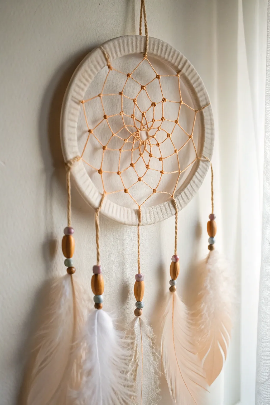 Embrace simplicity with a touch of boho charm: A dreamy paper plate dreamcatcher.