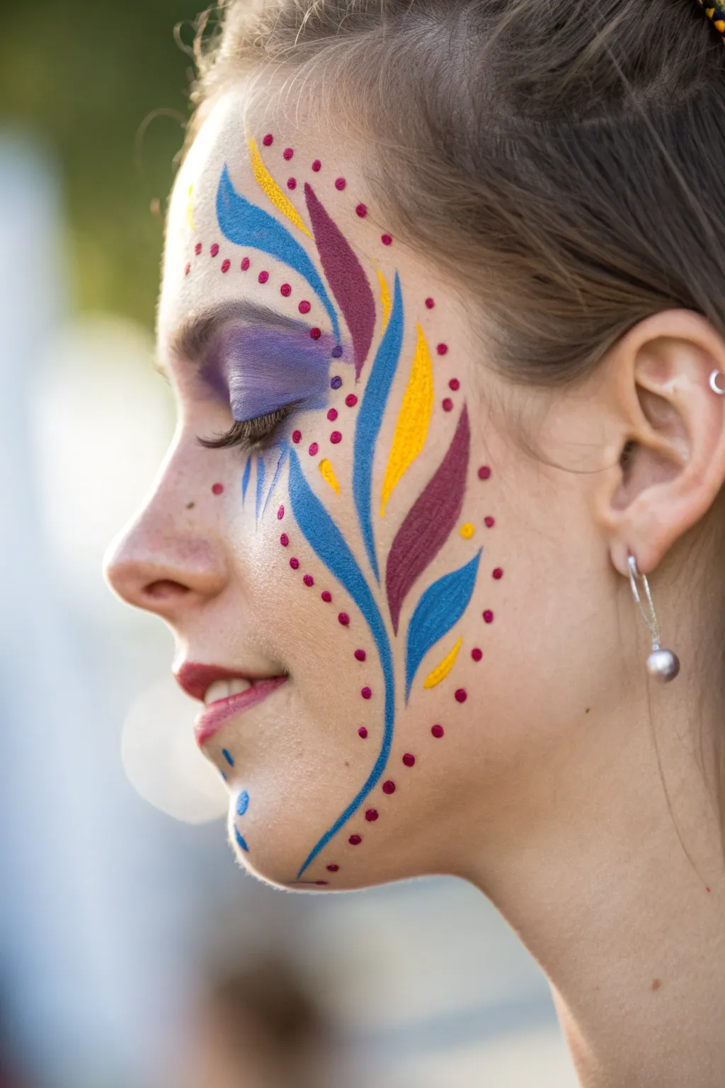 Embrace the spirit of summer with stunning carnival-inspired face art.
