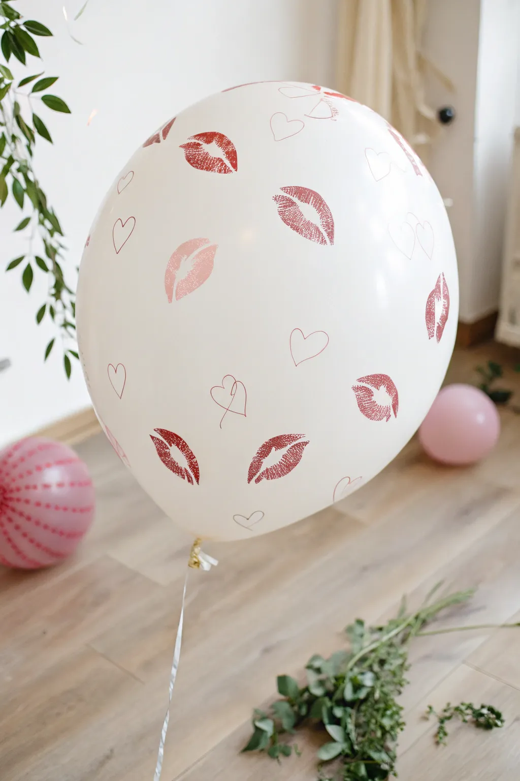 A kiss of charm: DIY your way to a playful Valentine's backdrop with kiss balloons.