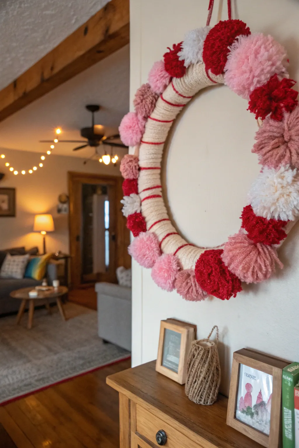Yarn and pom poms create a cozy and whimsical rustic wreath.