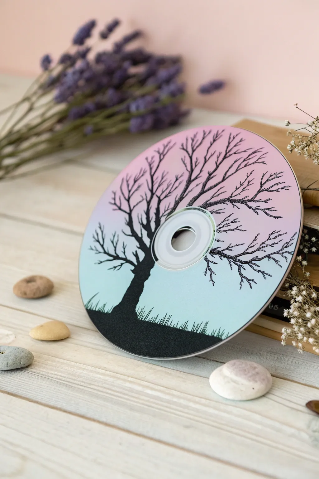 Embrace tranquility with this minimalist tree silhouette painting on a DVD, where simplicity meets natural beauty.
