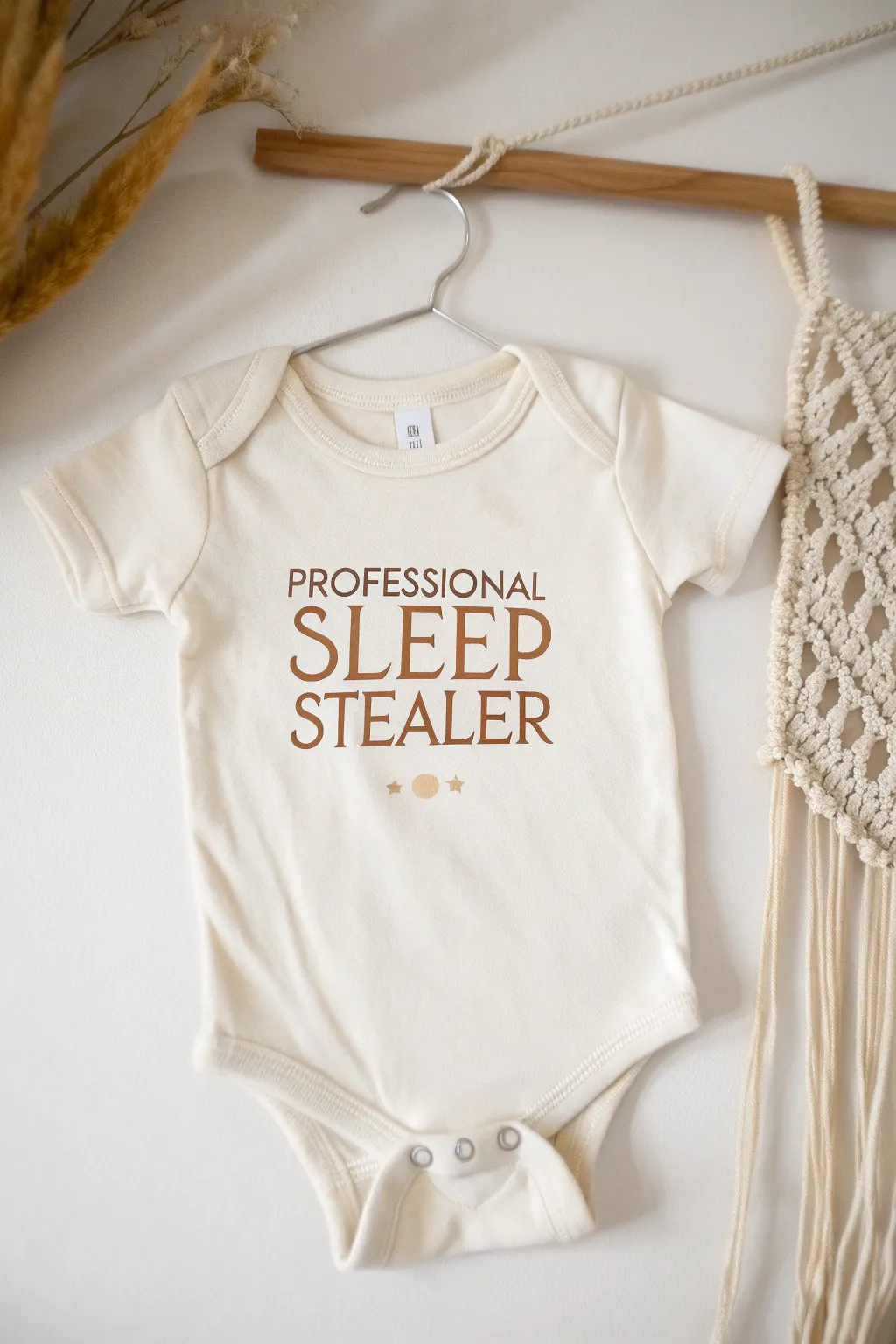 Embrace the humor in sleepless nights with a charming 'Professional Sleep Stealer' onesie.