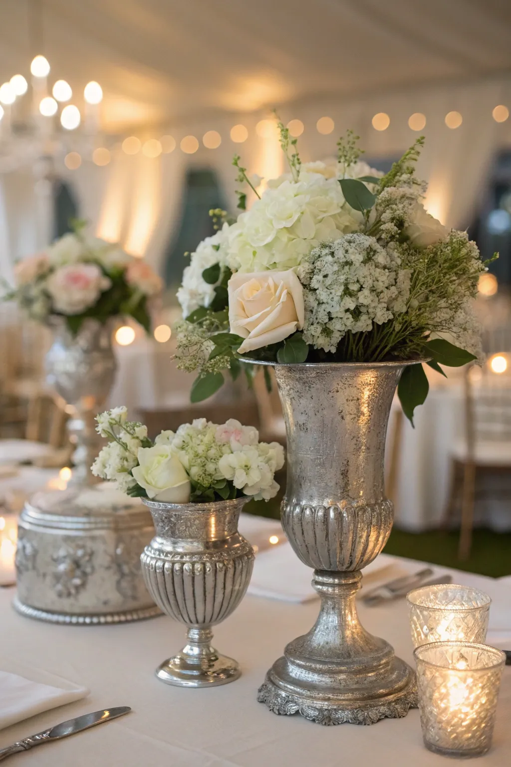 Antique silver vessels lend a timeless elegance to your table, pairing vintage charm with fresh floral beauty.