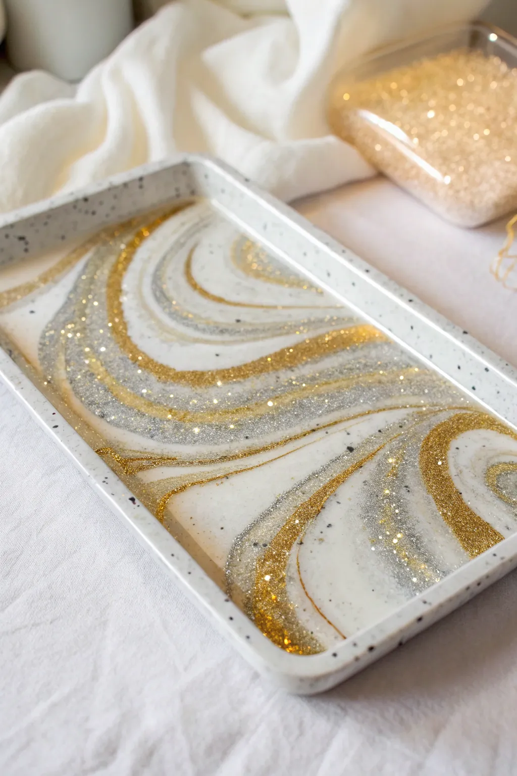 Sparkle in simplicity: A Scandinavian-inspired glitter explosion resin tray.