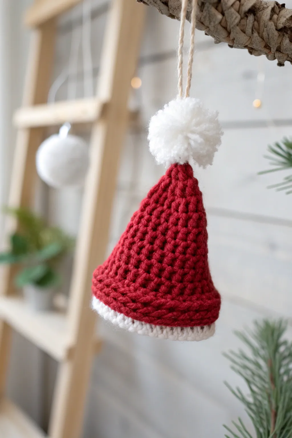 Add a touch of handcrafted charm to your tree with this cozy Santa yarn hat ornament.