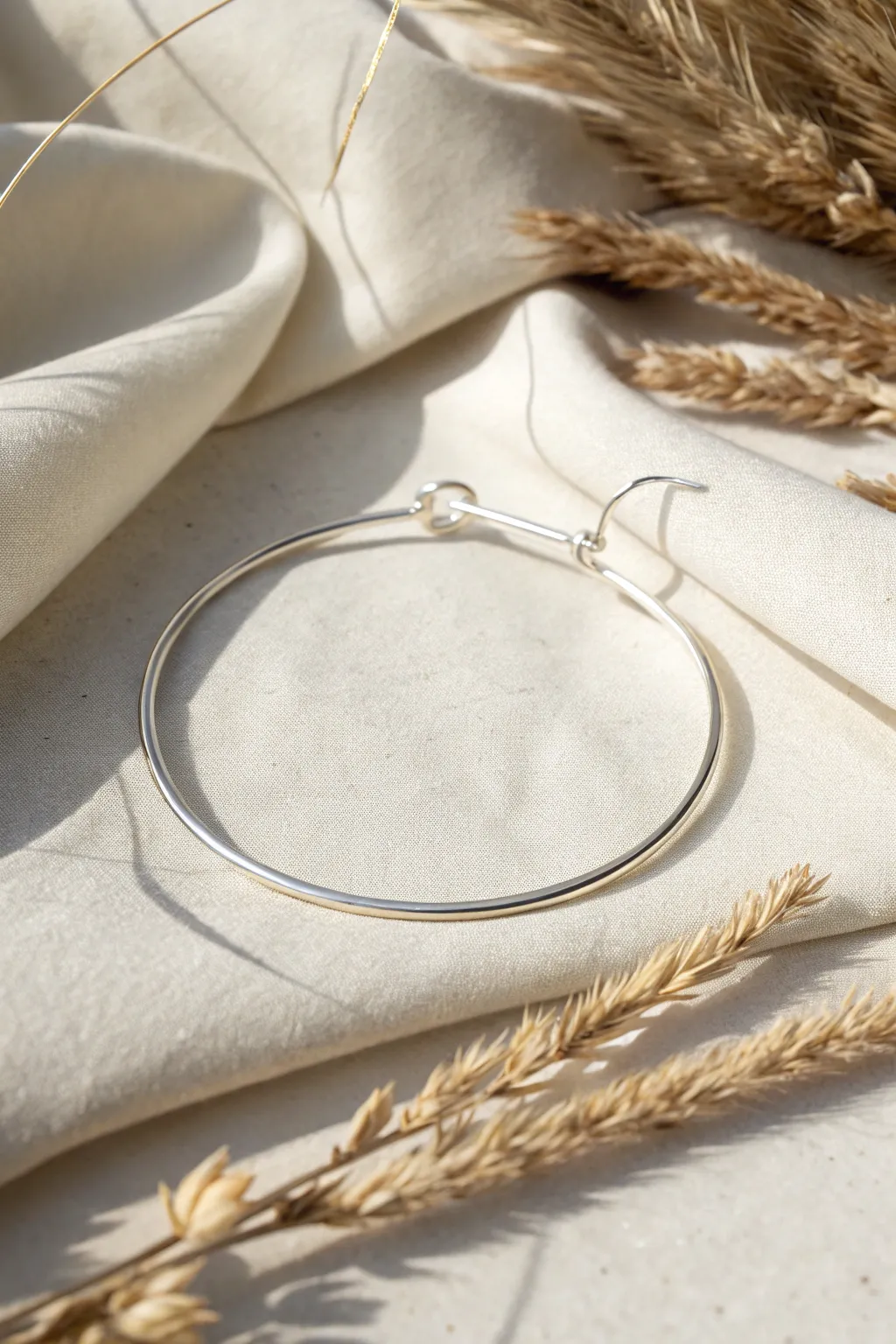 Embrace timeless elegance with this handcrafted silver wire hoop bracelet, perfect for any occasion.