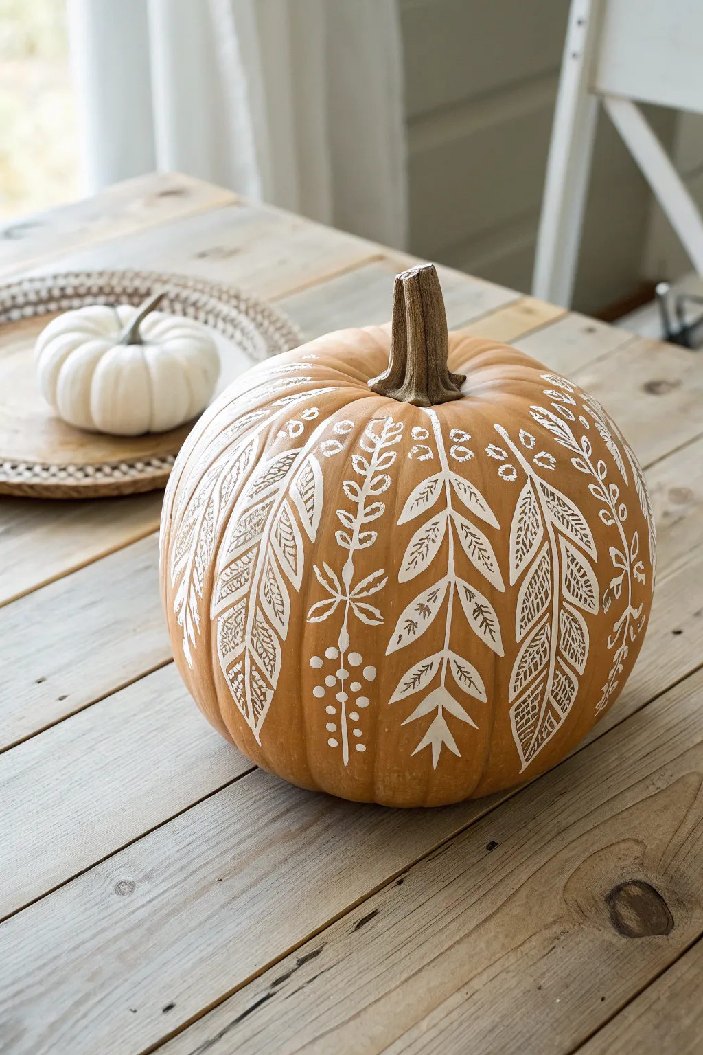 Elevate your autumn decor with a stenciled wooden pumpkin masterpiece, where simplicity meets artistry.